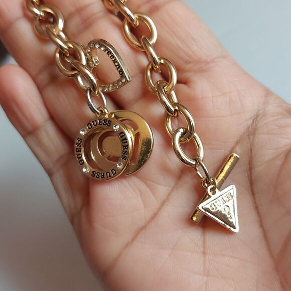 GUESS Gold Tone Heart Paved and  Logo Charms Toggle Clasp Bracelet - Picture 4 of 5